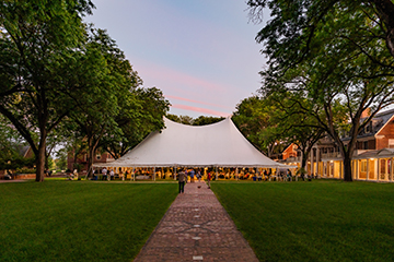 A reunion party underneath a tent. Links to Gifts of Real Estate