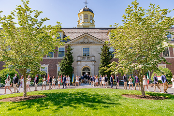 Students walking out of a building. Link to Life Stage Gift Planner Ages 45-65 Situations.