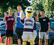 Photo of smiling students with the mascot. Links to Gifts That Pay You Income